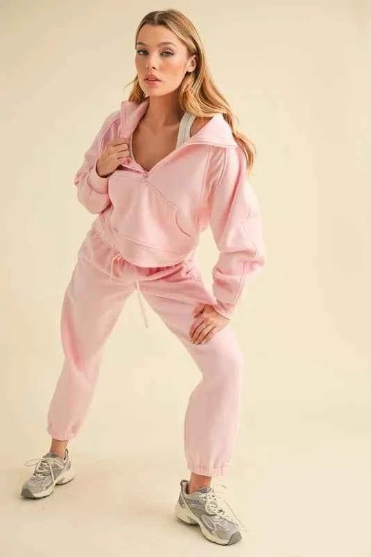 Trendy pink Aemi+Co elastic waist joggers paired with a matching hoodie for a stylish casual look
