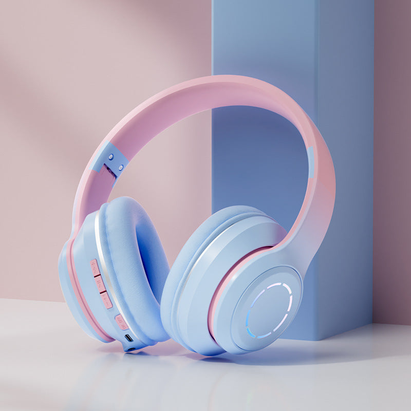 Gradient Bluetooth headphones in pink and blue with adjustable headband and built-in controls