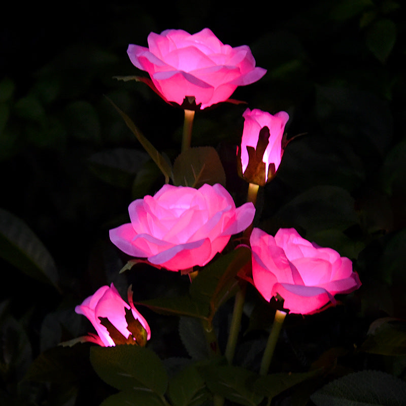 LED solar rose garden lamp glowing softly in a garden setting at night