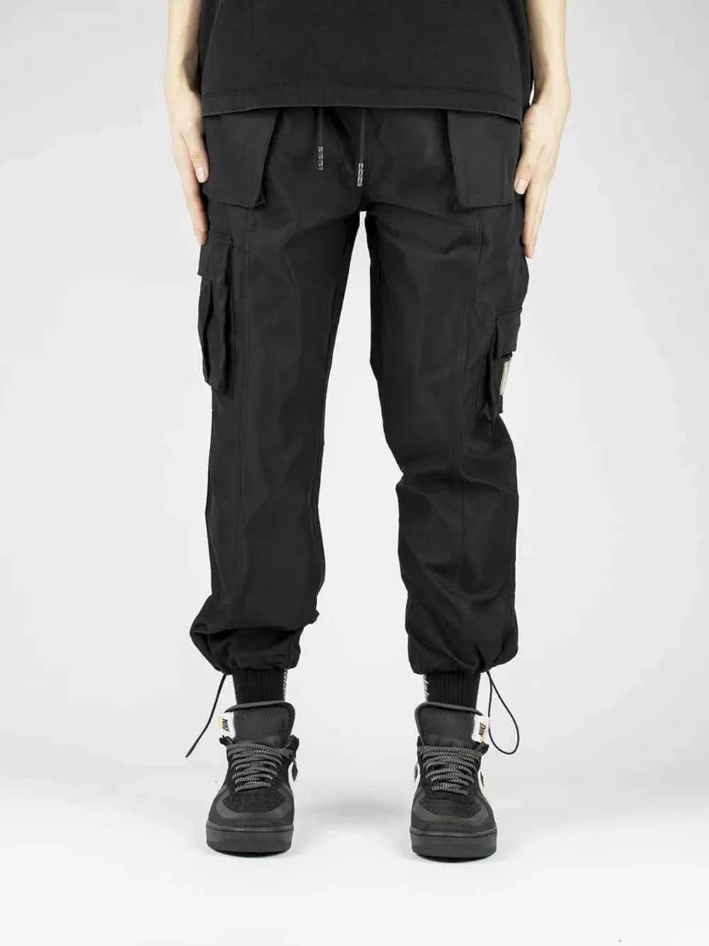 Men's drawstring cargo pants in black with adjustable cuffs and multiple pockets for functionality