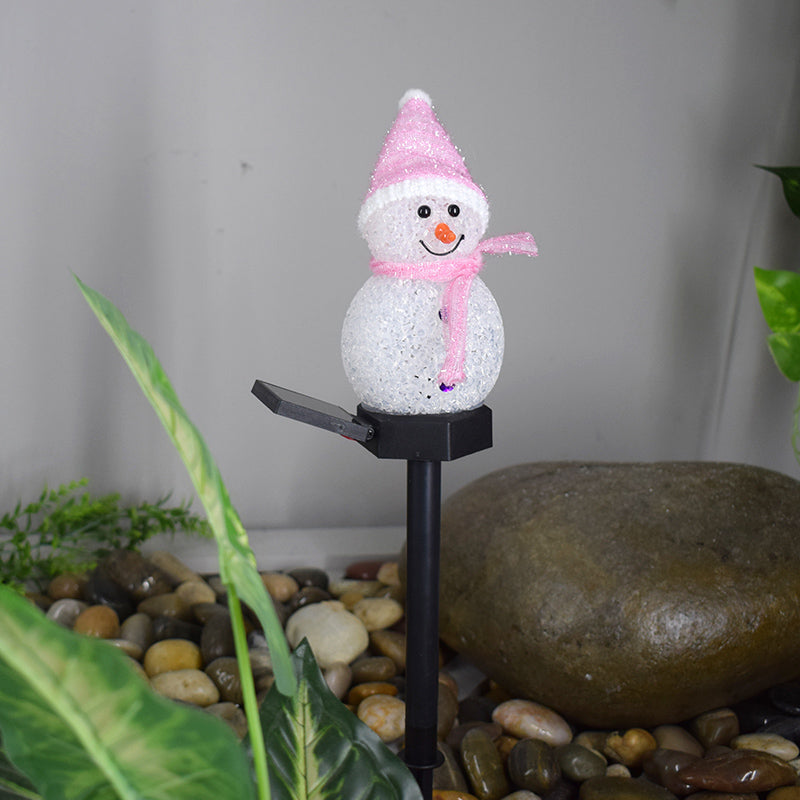 Solar snowman garden lamp with a pink hat and scarf, perfect for winter outdoor decor