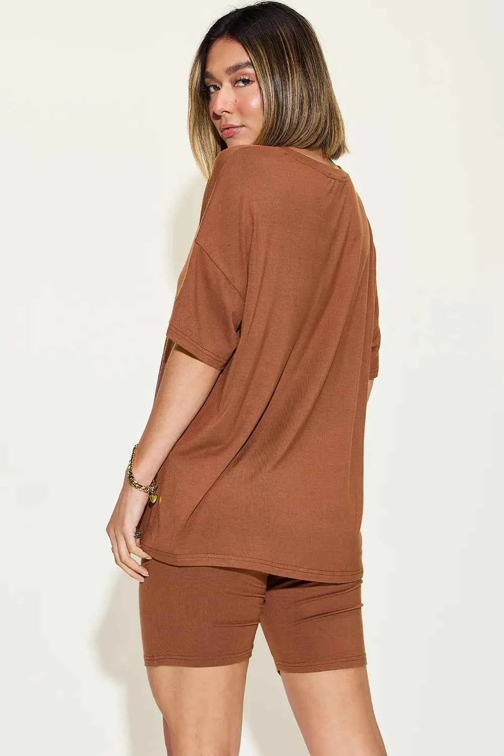 Stylish woman wearing trendy lounge wear for women in brown, featuring a relaxed fit top and matching shorts