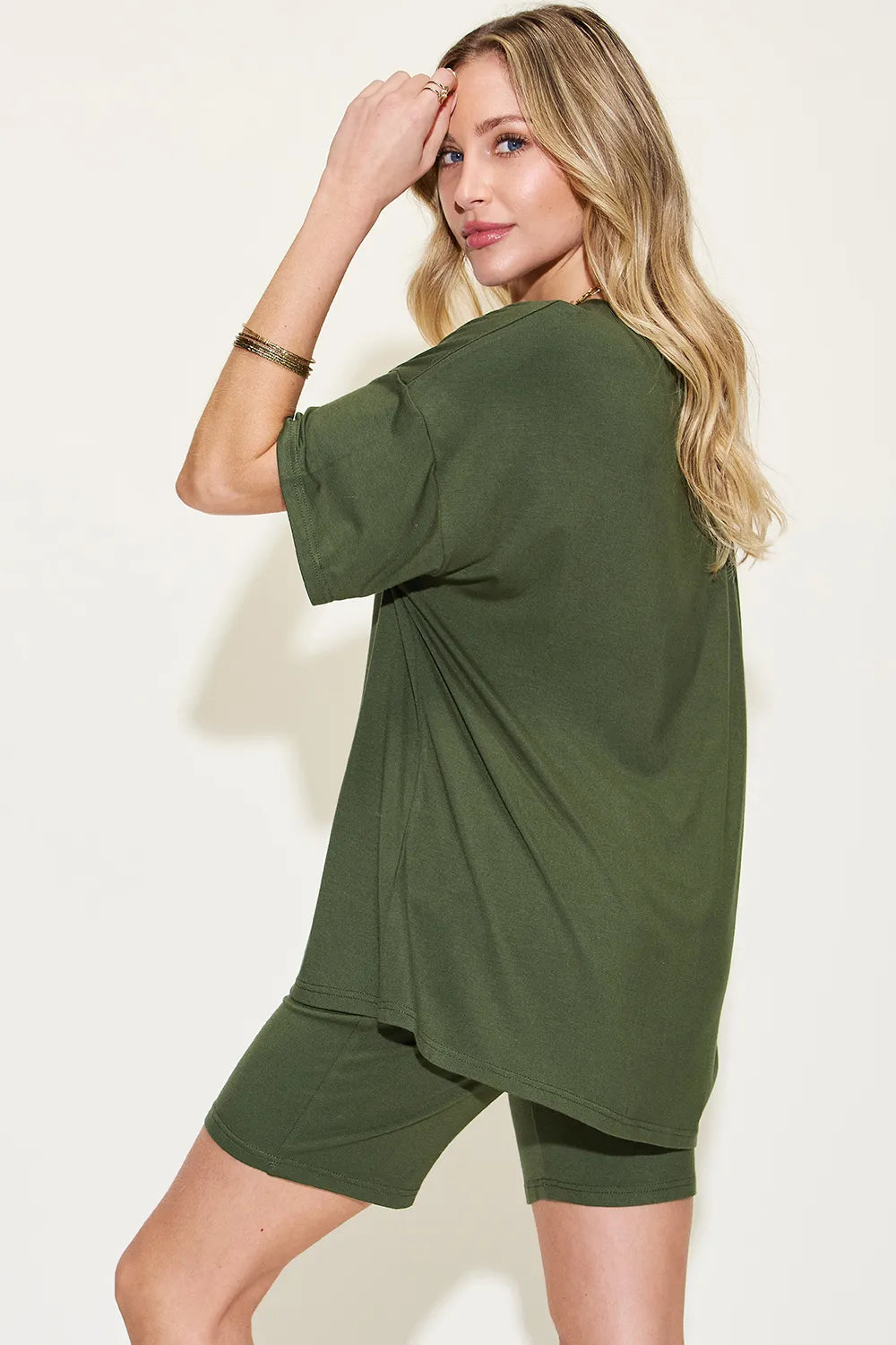Model wearing olive green trendy lounge wear for women, featuring a relaxed t-shirt and matching shorts