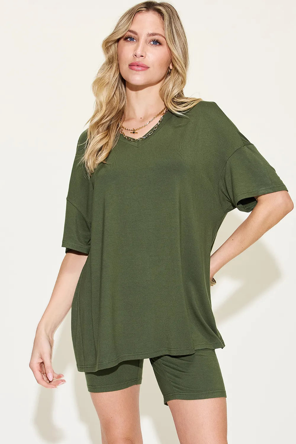 Stylish olive green trendy lounge wear for women including a loose top and fitted shorts