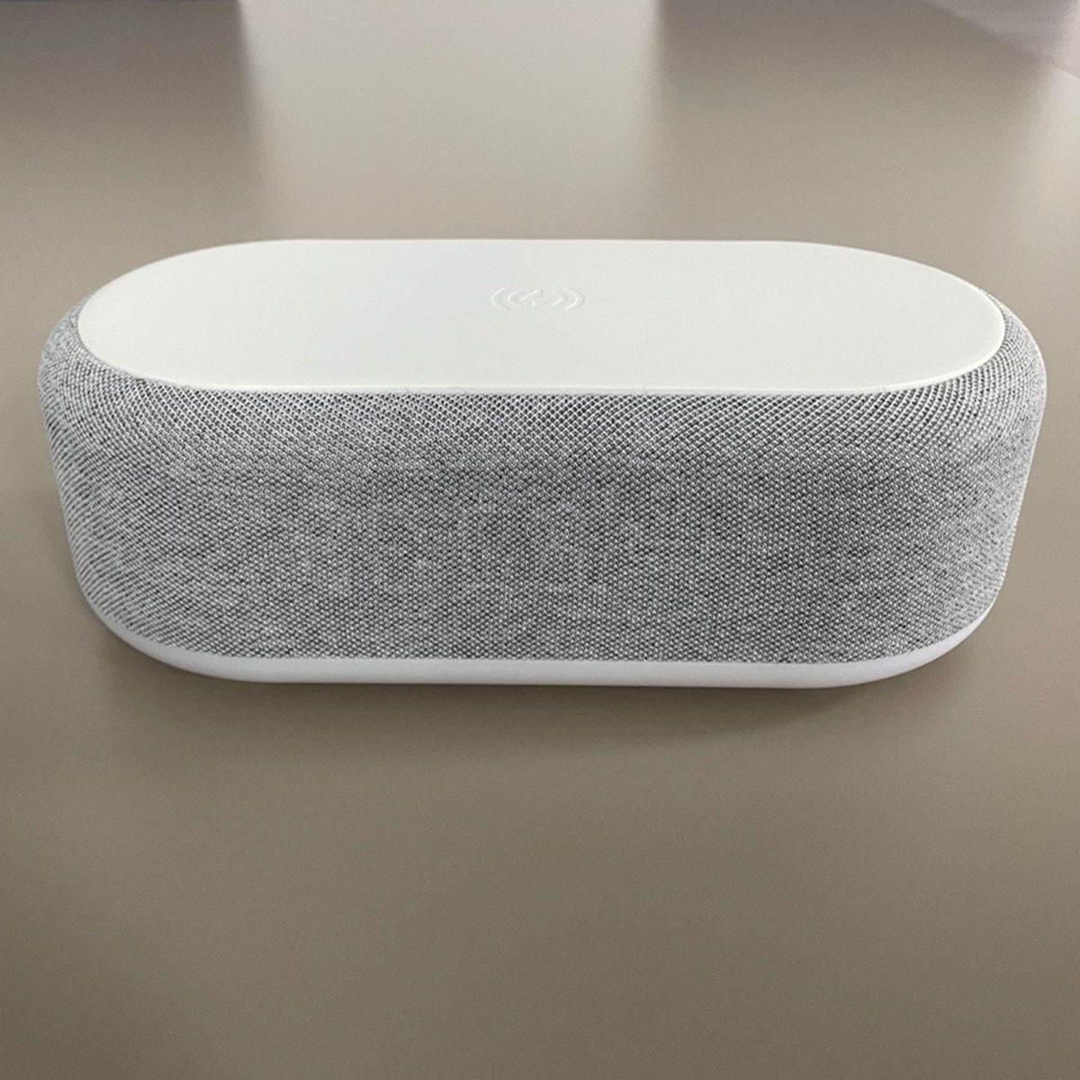 Wireless charging dock with alarm clock in a sleek gray and white design for convenient device charging