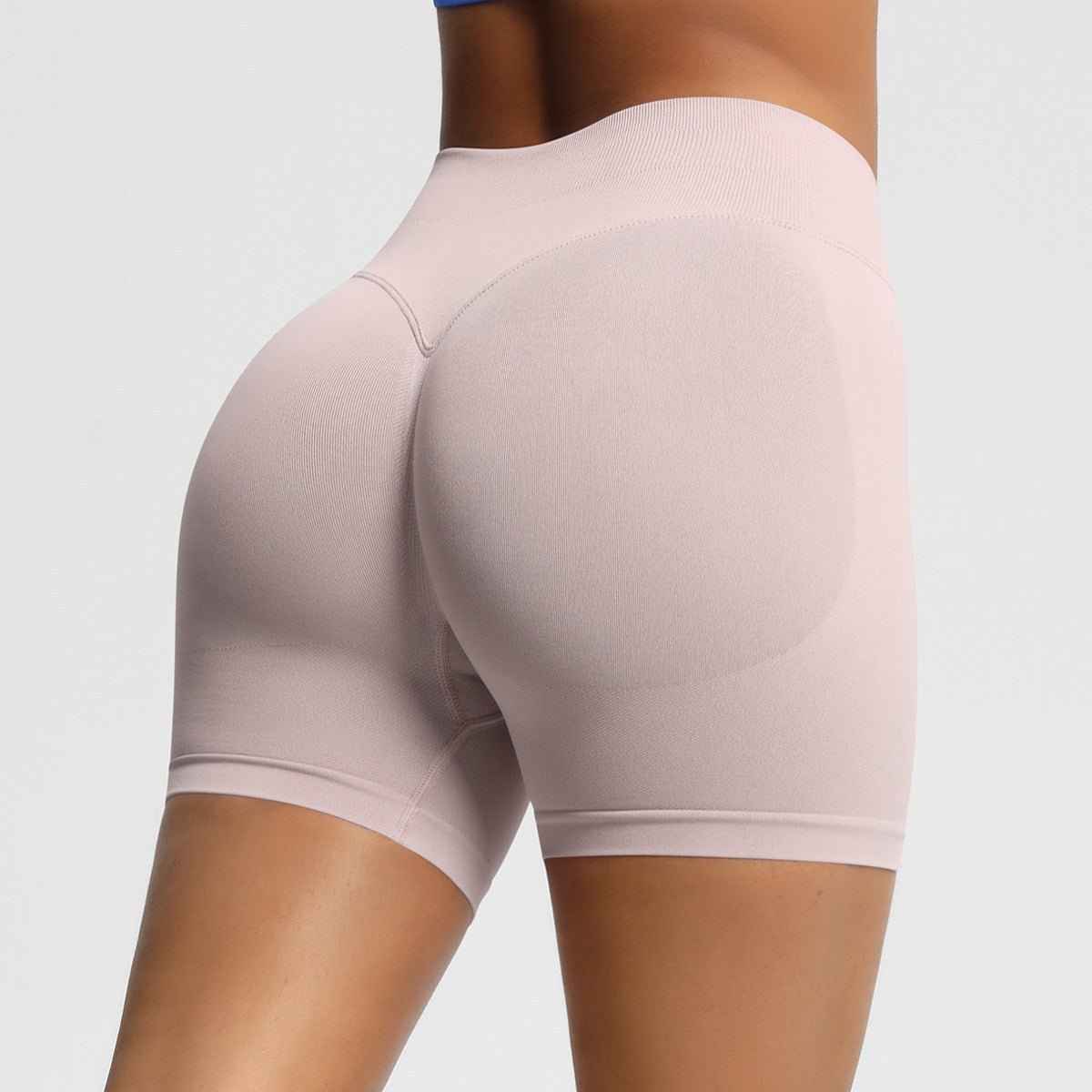 Women's seamless fitness shorts in light pink, designed for comfort and flexibility during workouts