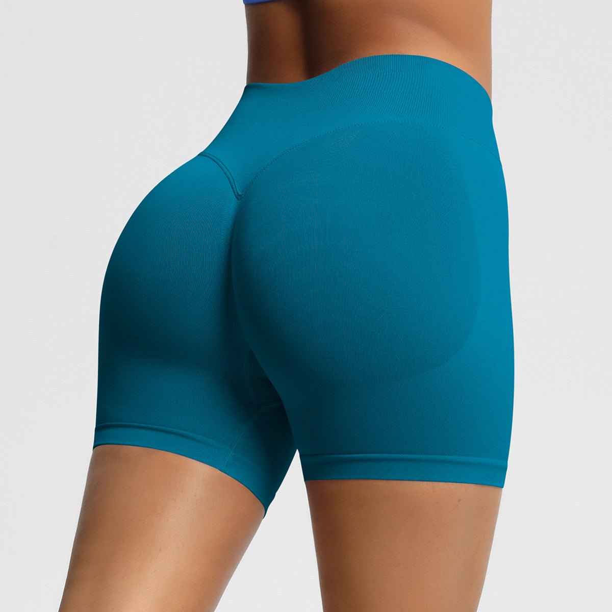 A close-up of women's seamless fitness shorts in teal, designed for comfort and flexibility during workouts