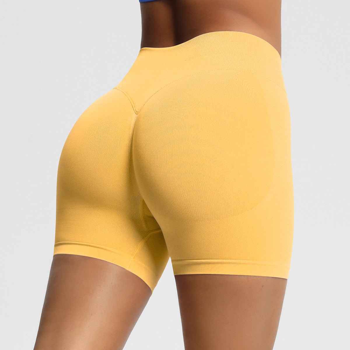 Yellow women's seamless fitness shorts designed for comfort and flexibility during workouts