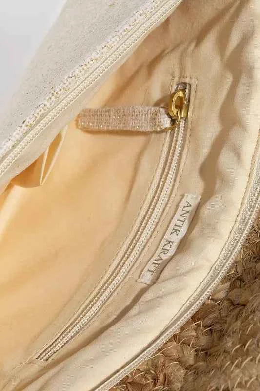 Interior view of an eye pattern clutch purse showing lined compartment and zip pocket