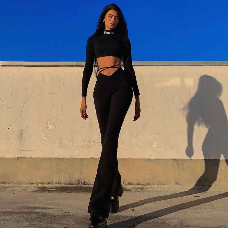 Stylish model wearing black flared track pants with high comfort paired with a cropped top