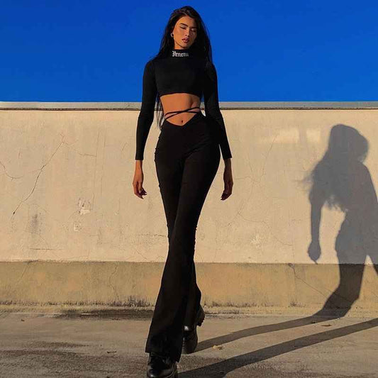 Stylish model wearing black flared track pants with high comfort paired with a cropped top