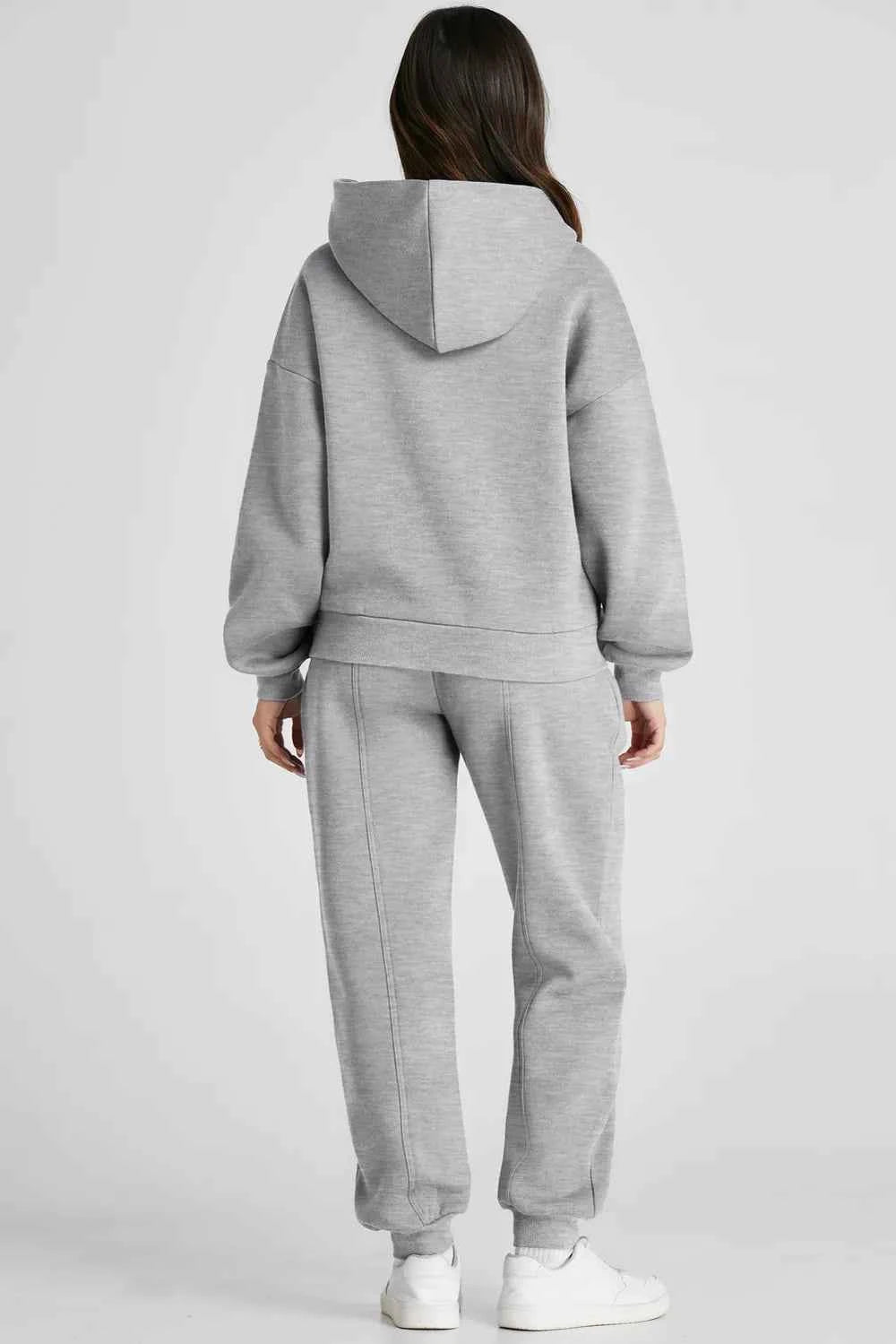 Stylish grey tracksuit for women featuring a cozy hooded sweatshirt and matching jogger pants