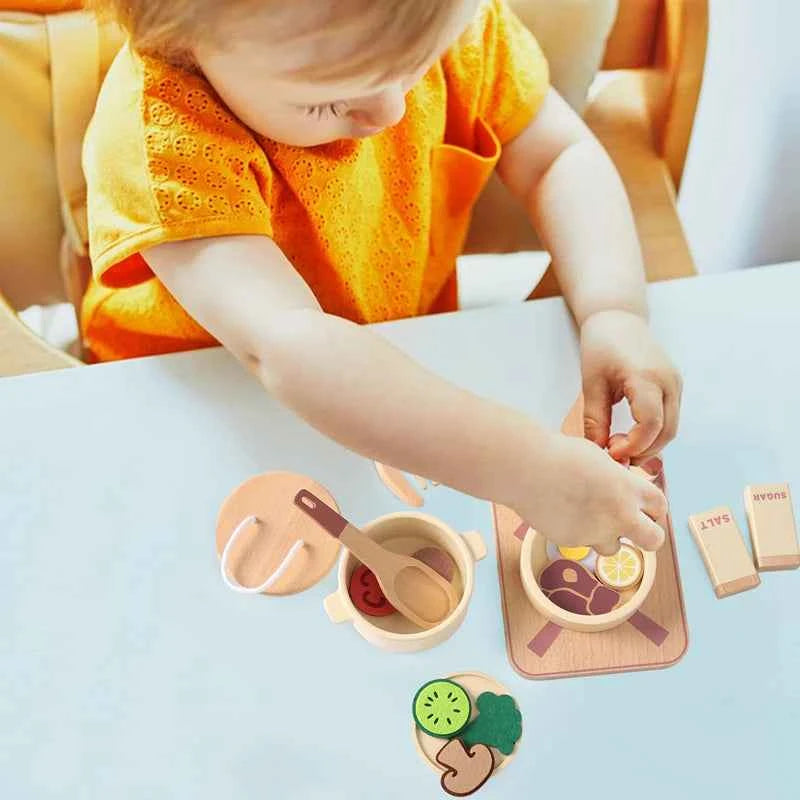 Child playing with a kid wooden kitchen toy set featuring colorful food and cooking accessories