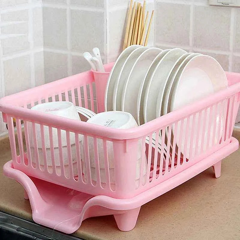 Pink kitchen drainage rack with plates and utensils for drying in the kitchen