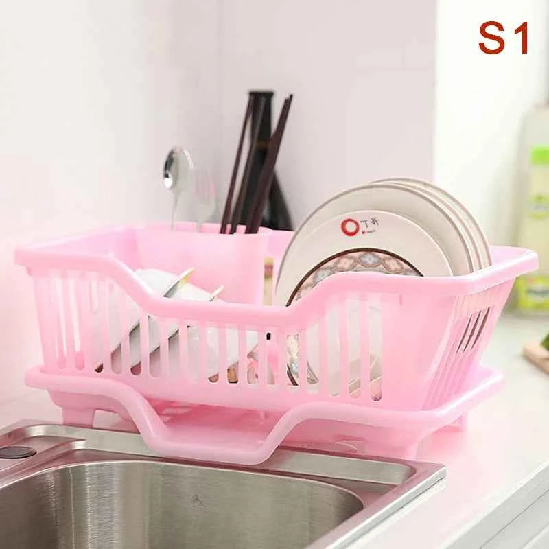 Pink kitchen drainage rack for drying dishes and utensils near the sink