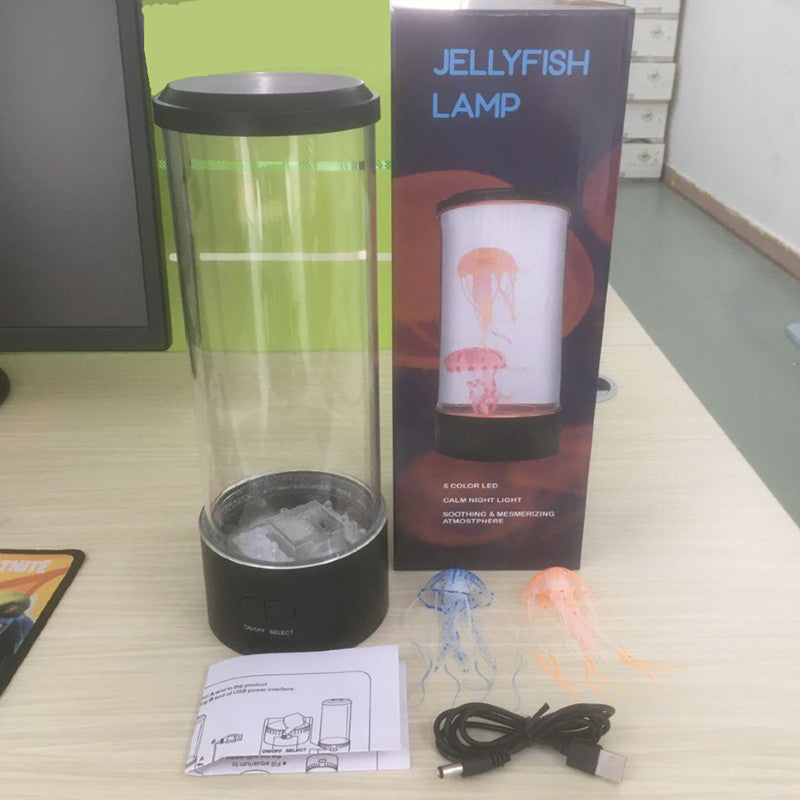 LED jellyfish night light with colorful jellyfish effects, USB cable, and user manual displayed on a desk