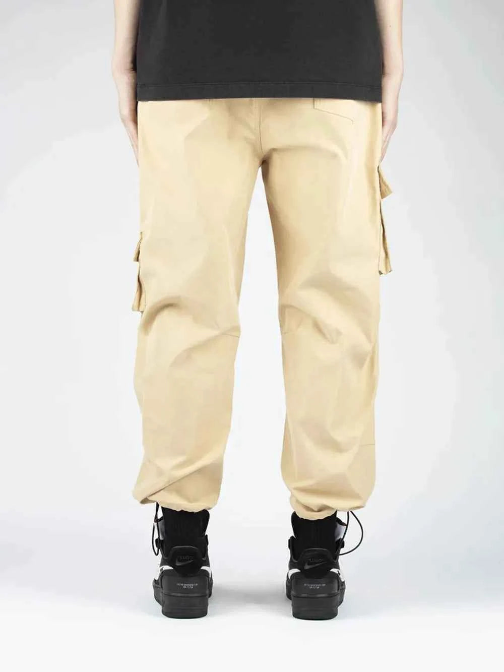 Men's drawstring cargo pants in beige with multiple pockets for a stylish look