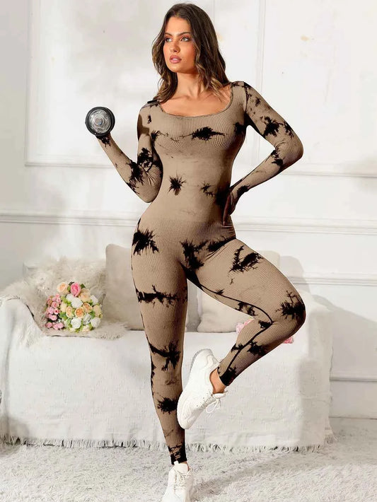 Stylish woman in a premium fitness jumpsuit, showcasing a modern design and holding a dumbbell