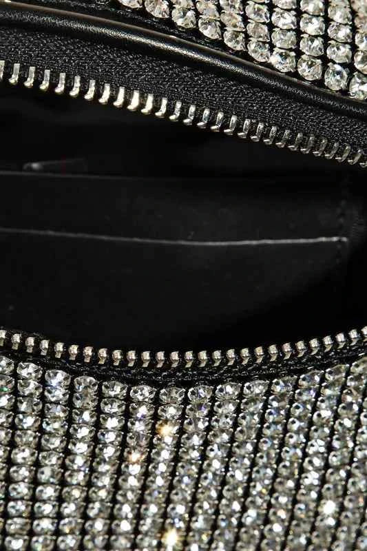 Close-up of a stylish rhinestone crossbody bag with a zippered compartment and sparkling stones