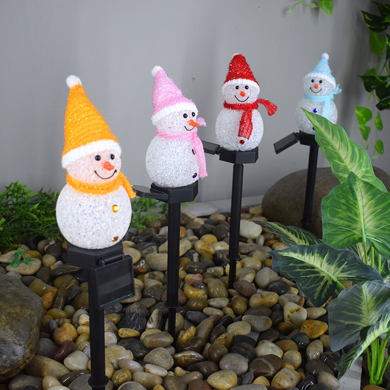 Four colorful solar snowman garden lamps with snowman designs and festive hats for outdoor decoration