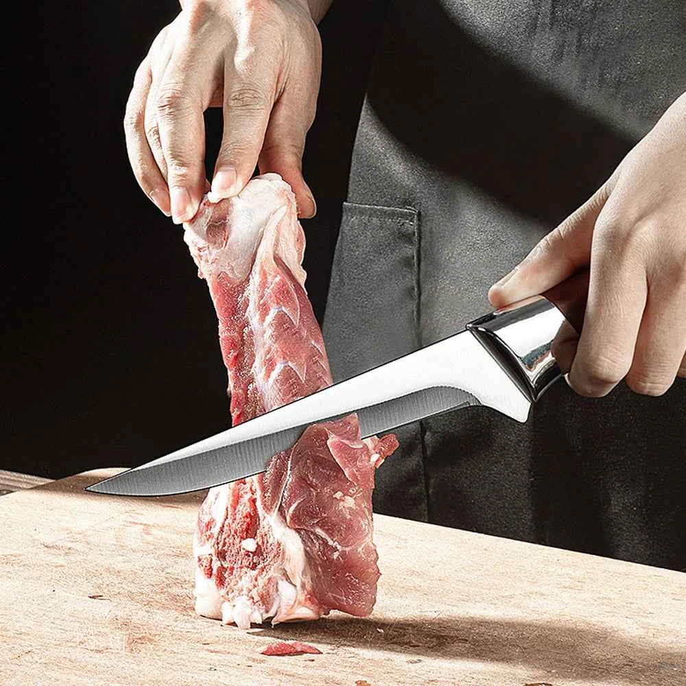 Stainless steel boning knife cutting meat with precision on a wooden cutting board