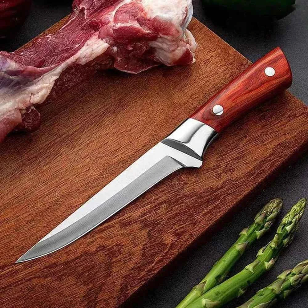 My Store stainless steel boning knife with a wooden handle on a cutting board with meat and vegetables