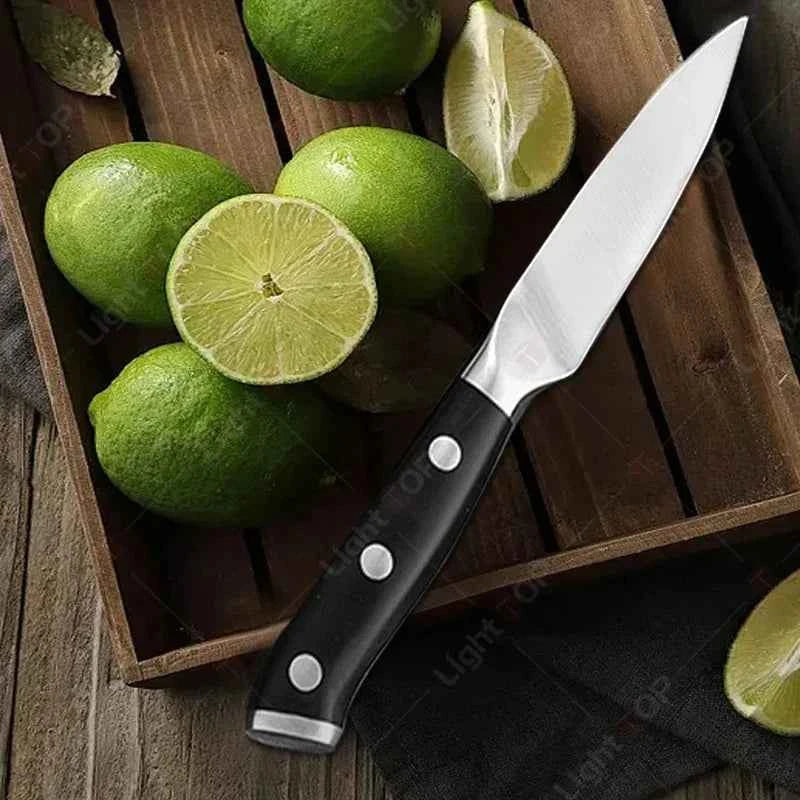 Sharp stainless steel paring knife on a wooden surface with fresh limes for easy fruit cutting
