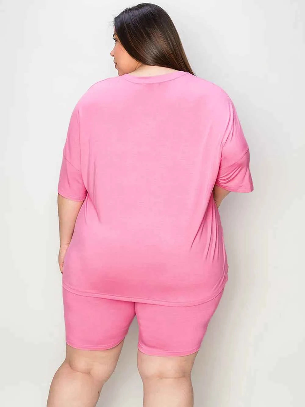 Plus size woman in trendy lounge wear for women featuring a relaxed fit pink top and shorts
