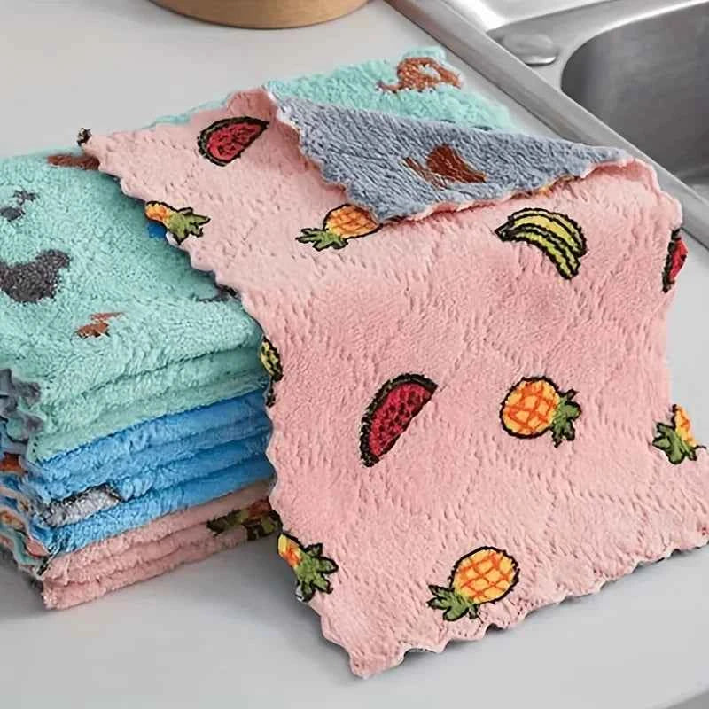 Colorful embroidered water-absorbent dish cloths stacked, featuring fruit designs for kitchen use