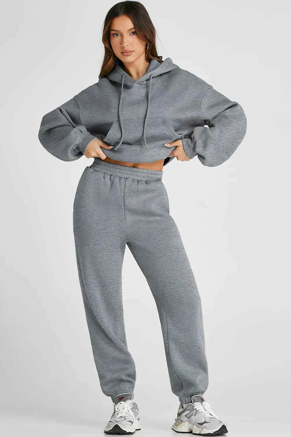 Trendy women's casual activewear set in grey featuring a cropped hoodie and matching joggers