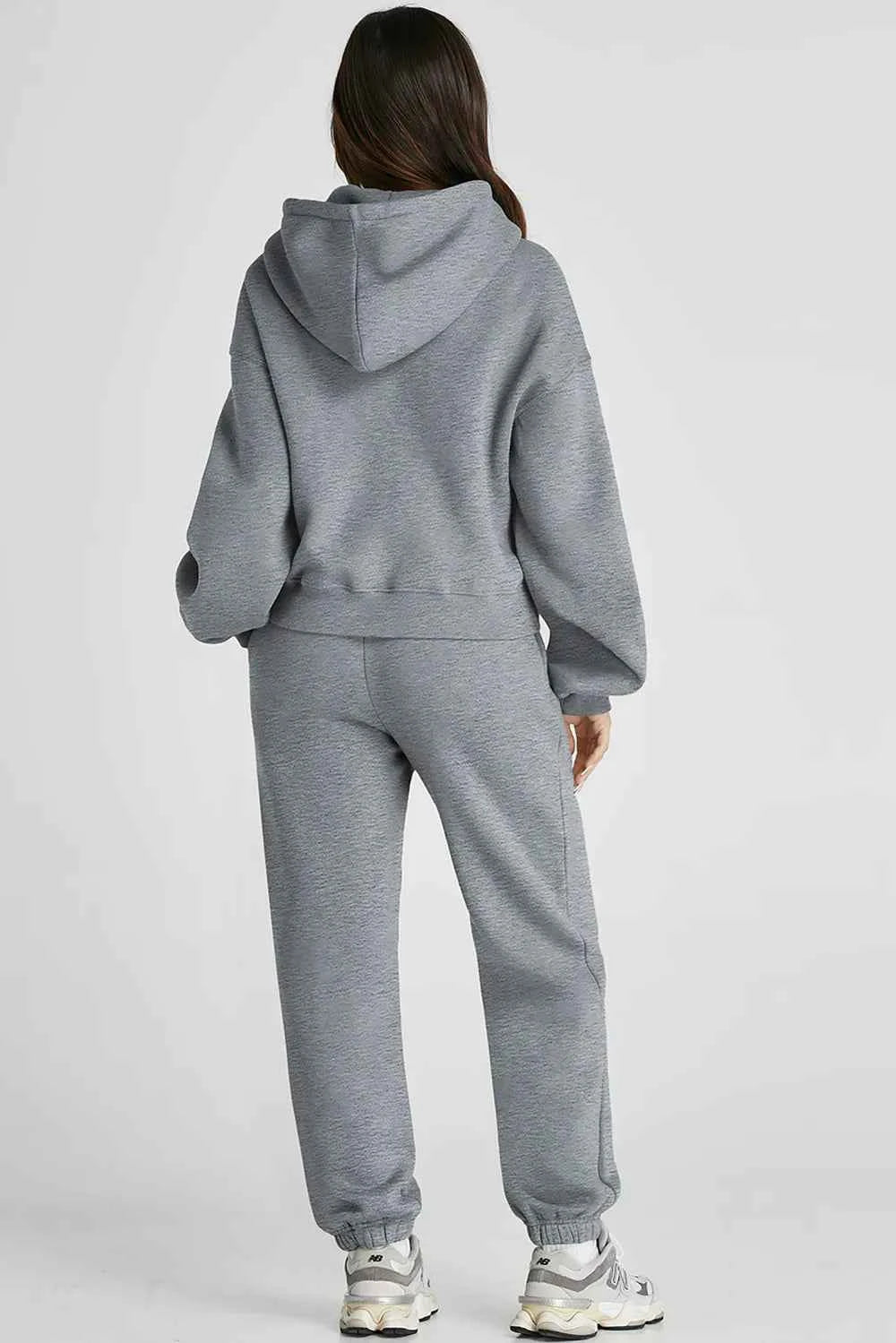 Woman wearing grey women's casual activewear featuring a hoodie and sweatpants for comfort and style