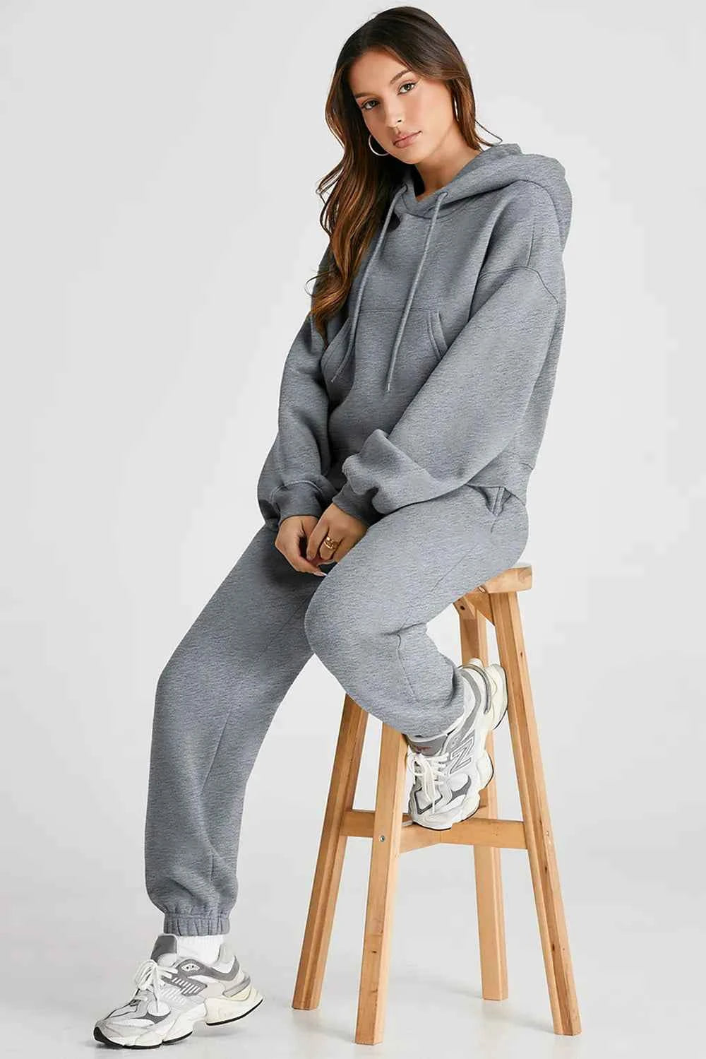 Trendy women's casual activewear set in gray featuring a comfortable hoodie and matching sweatpants