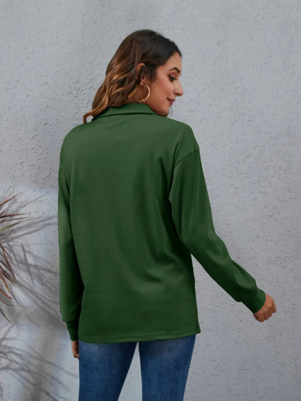 Back view of a green women's classic blouse with long sleeves, perfect for casual or professional wear